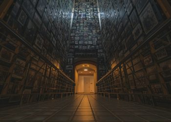 a very long hallway with a bunch of pictures on the wall