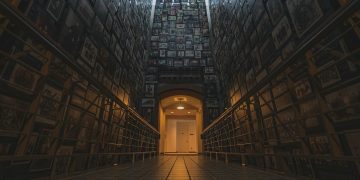 a very long hallway with a bunch of pictures on the wall