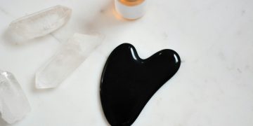 black ink on white surface near bottle