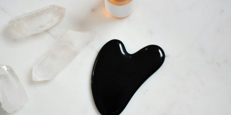 black ink on white surface near bottle