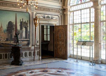 A large room with a large painting on the wall