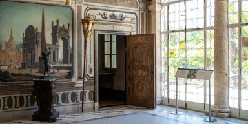 A large room with a large painting on the wall