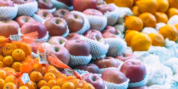 a display of apples, oranges, and other fruits