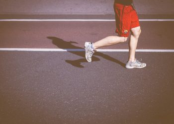 person running on concrete road