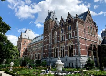 brown concrete building near green grass field during daytime