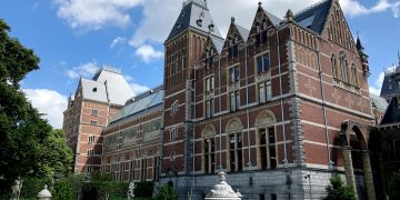 brown concrete building near green grass field during daytime