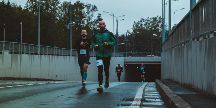 group of people running on street