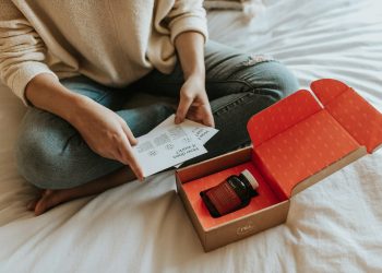 red-labeled amber glass tub on a box