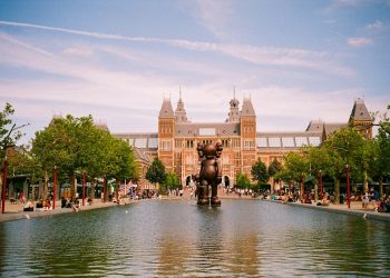 a large building with a fountain in front of it
