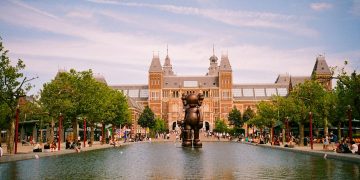 a large building with a fountain in front of it
