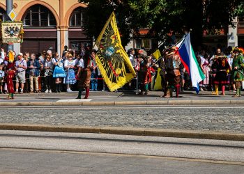 a group of people standing on the side of a road