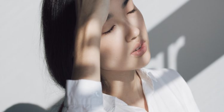 woman leaning on white table
