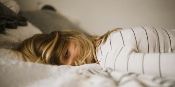 woman lying on bed