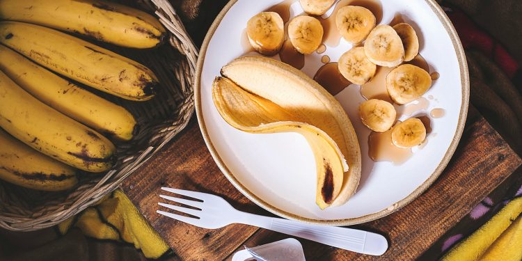 sliced ripe banana on round white ceramic plate