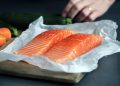 raw fish meat on brown chopping board