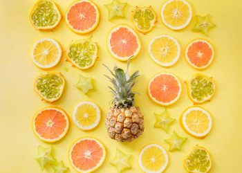 pineapple surrounded by citrus fruits