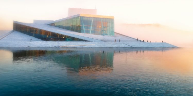 gray building near body of water under white sky