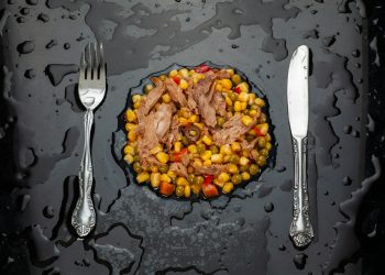 stainless steel fork and bread knife on black ceramic plate