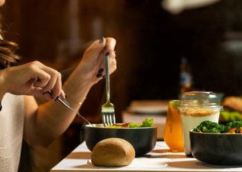 person holding silver fork and knife