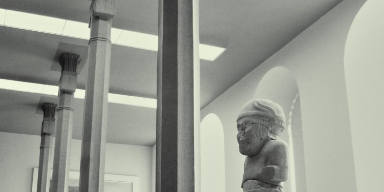 white concrete statue of man