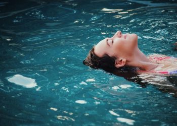 woman floating on body of water