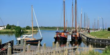 a group of boats docked at a pier