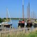 a group of boats docked at a pier