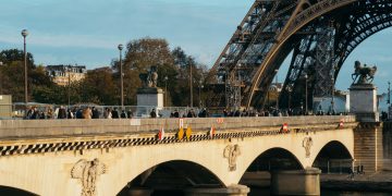 white bridge over river under white clouds during daytime