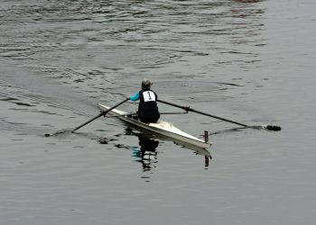 a person rowing a boat on a body of water