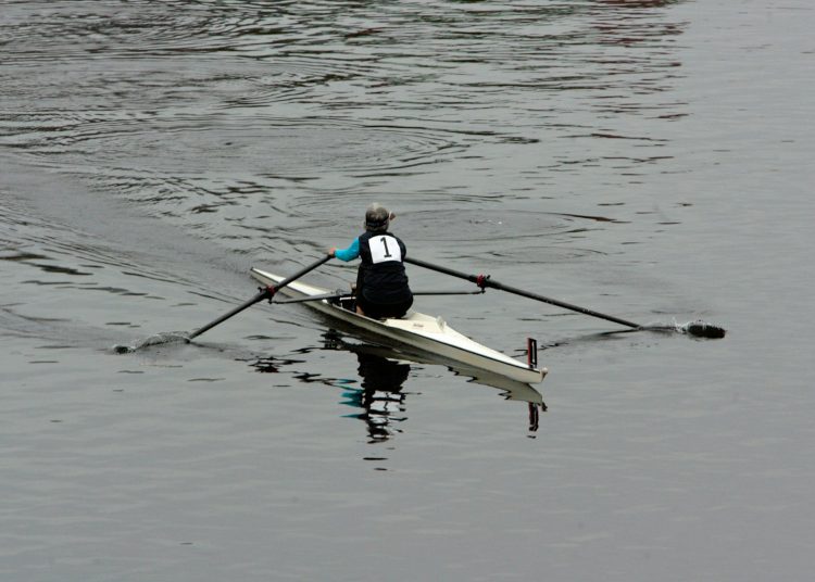 a person rowing a boat on a body of water