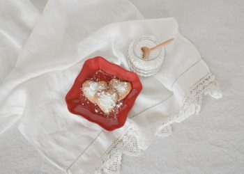 flat lay photography of heart-shaped cookies on red plate