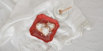 flat lay photography of heart-shaped cookies on red plate