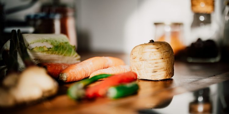 sliced vegetables on brown wooden chopping board