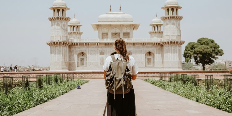 woman near beige painted building